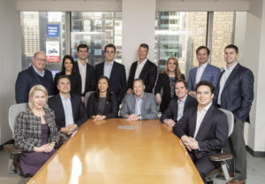 Spire Capital team members posed in the board room