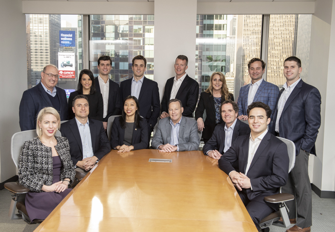 Spire Capital team members posed in the board room - Spire Capital