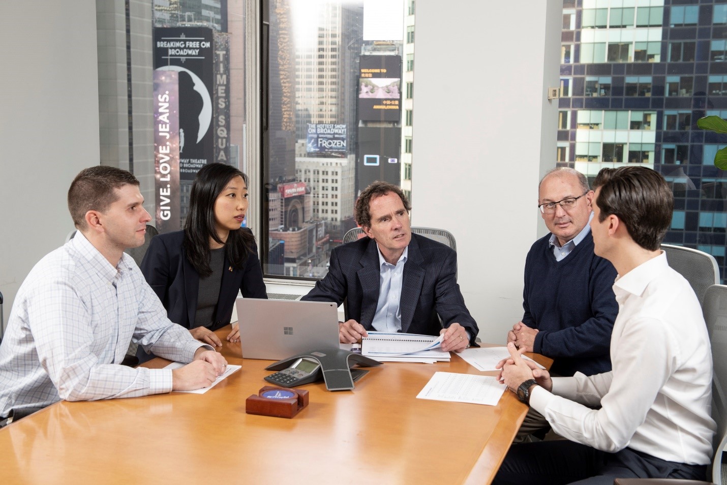 Spire Capital team members meeting in a conference room